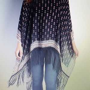 Lightweight patterned poncho with weaved fringe